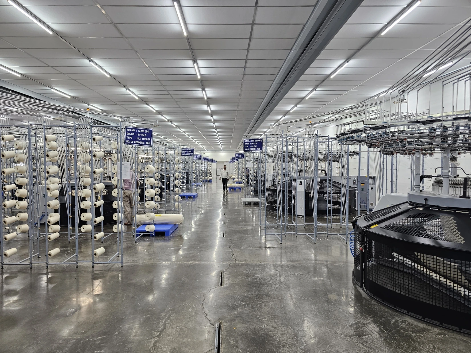 Rows of circular knitting machines and yarn creels
