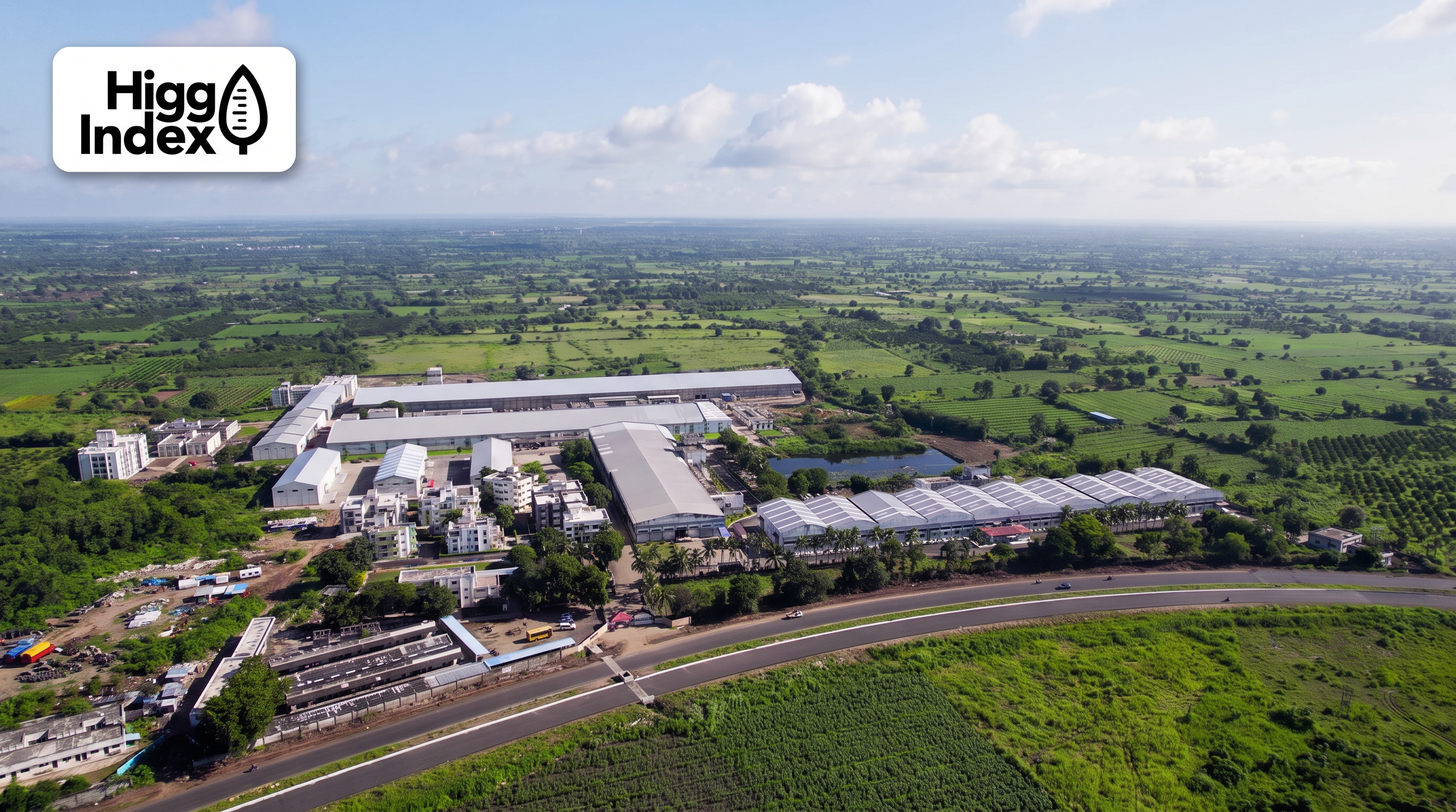 Higg Index logo badge over an aerial view of the Bhagirath mill campus surrounded by green farmland
