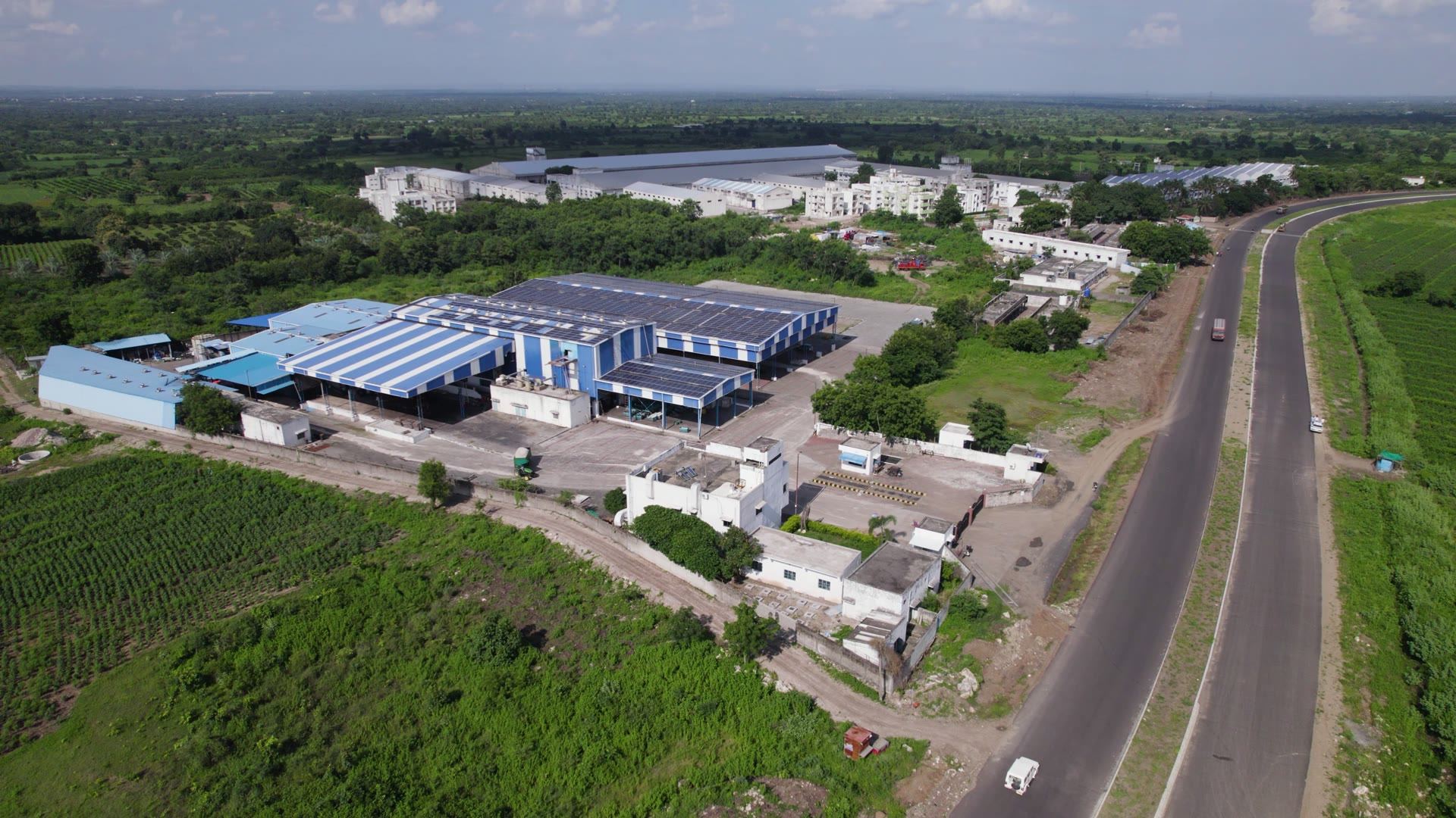 Mill campus with solar-ready roofs beside farmland